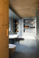 Concrete bathroom with wooden ceiling 