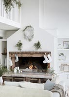 Rustic fireplace with christmas decorations in white and green