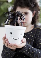 Child holding plant pots