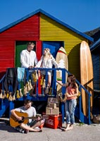 Family outside colourful beach huts 