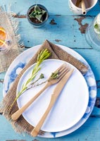 Wooden cutlery on plate - outdoor dining table 