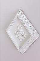 White carved wooden plaque on wall 