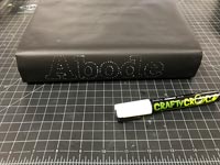 Decorated book spine - the word abode in white spots on black book 