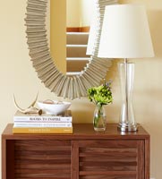 Wooden slatted cabinet, lamp and mirror in modern hallway 