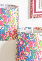 Colourful lampshades created using wallpaper to cover them