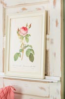 Painting of a rose against distressed painted wooden door 