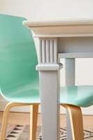 Detail of table leg and chair in modern dining room 