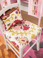 Patterned colourful fabric chair cover and matching cushion 