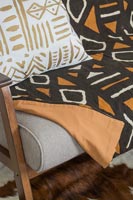 Patterned throw and cushion on sofa 
