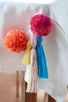 Pom poms and tassels on tablecloth