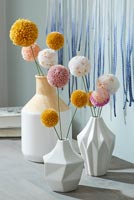 Vases with decorative pom poms 