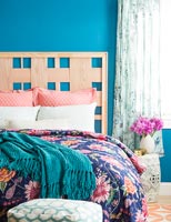 Wooden headboard in colourful bedroom 