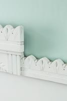 Carved architrave used as headboard 