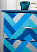Details of colourful patterned chest of drawers 
