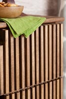 Detail of wooden slatted chest of drawers 
