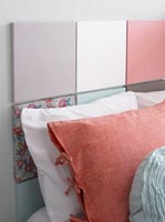 Colourful headboard made from square panels covered in t-shirt fabric 