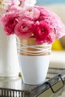 Pink roses in a gold and white vase 