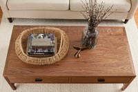 Wooden coffee table with fish tail ornament and basket 