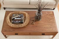 Wooden coffee table with fish tail ornament and basket 