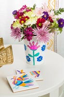 Colourful flower arrangement in painted vase 