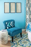 Blue chair in colourful blue themed bedroom 