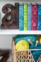 Items including colourful books on bookshelves 