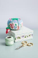 Pin cushion on sewing box with accessories 