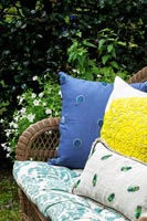 Rattan outdoor sofa covered in cushions 
