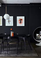 Modern dining room with black painted wall