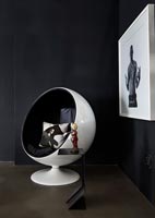 Retro ball chair in black and white room 