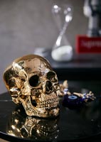 Gold skull ornament on black table 