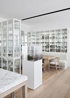 Glazed white display cases around dining table 
