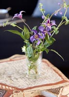 Small vase of wildflowers on wooden side table 