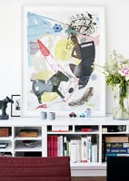 Colourful modern artwork on bookcase 