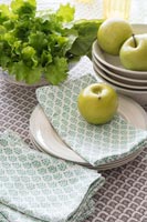 Apples and lettuce on dining room table 