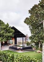 Modern house and gardens with outdoor living area 