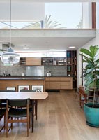 Contemporary open plan living space with concrete mezzanine