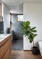 Contemporary bathroom with slate tiling in shower cubicle 
