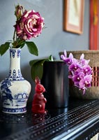 Single vintage rose in vase and orchid 
