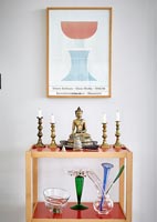 Trolley with Buddha ornament and candlesticks 
