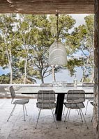 Outdoor table and chairs on terrace with sea view