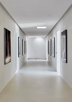Minimal white corridor with artwork on the walls  
