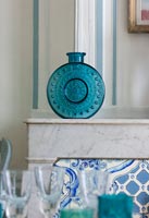 Blue glass vase on mantelpiece 