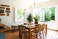 Country dining room with open French windows 