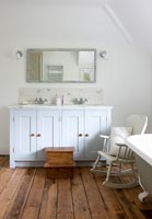 Rocking chair and  steps for child in country bathroom 