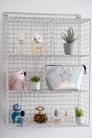 Wall mounted wire shelf unit with perfume and accessories 