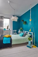 Modern bedroom with blue painted walls