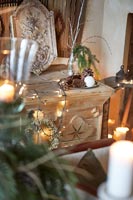 Christmas wreath and fairy lights on large wooden carved sideboard 