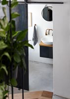 Small monochrome bathroom with polished concrete floor 