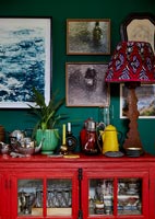Bright red dresser with tea and coffee pots display 